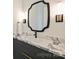 Bathroom with a marble countertop, black hardware and modern light fixtures at 3473 Willow Oak Rd, Charlotte, NC 28209