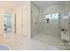 Modern bathroom featuring a glass-enclosed shower with a bench, and sleek fixtures at 3473 Willow Oak Rd, Charlotte, NC 28209
