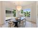 Elegant dining room featuring modern chandelier, large windows, and a decorative table at 3473 Willow Oak Rd, Charlotte, NC 28209