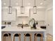 Modern kitchen featuring a large island with seating and stylish pendant lighting at 3473 Willow Oak Rd, Charlotte, NC 28209