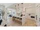 Open concept kitchen with island seating, contemporary lighting, and seamless flow to the dining area at 3473 Willow Oak Rd, Charlotte, NC 28209