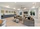 Bright living room featuring a wet bar, comfortable seating and natural light from large windows at 3473 Willow Oak Rd, Charlotte, NC 28209