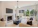 Bright living room with fireplace, TV, plush seating, and sliding doors to the outside at 3473 Willow Oak Rd, Charlotte, NC 28209