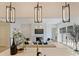 Bright living room with fireplace, contemporary lighting, and view from the kitchen island at 3473 Willow Oak Rd, Charlotte, NC 28209