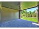 Covered patio with ceiling fan and stone flooring overlooks manicured lawn at 3473 Willow Oak Rd, Charlotte, NC 28209