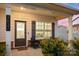 Inviting front porch with a seating area, decorative shrubs, and a view of the charming neighborhood at 3637 Allenby Pl, Monroe, NC 28110