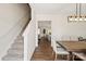 Hallway with wood floors leads to the staircase and the dining area adjacent to a kitchen at 3637 Allenby Pl, Monroe, NC 28110