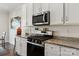 Modern kitchen features granite countertops, stainless steel appliances, and white cabinetry at 3637 Allenby Pl, Monroe, NC 28110