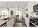 Well-lit kitchen with granite countertops, stainless appliances, and a view of the dining table at 3637 Allenby Pl, Monroe, NC 28110