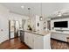 Open kitchen with granite countertops, stainless steel appliances, and a view into the living room at 3637 Allenby Pl, Monroe, NC 28110