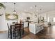 Bright kitchen features white cabinets, granite counters, stainless appliances, island with seating, and adjacent dining area at 3637 Allenby Pl, Monroe, NC 28110