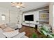 Well-lit living room with a large sectional sofa, modern entertainment center, and a view of the doorways at 3637 Allenby Pl, Monroe, NC 28110