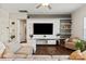 Bright living room featuring a modern entertainment center, comfortable seating, and hardwood floors at 3637 Allenby Pl, Monroe, NC 28110