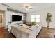Spacious living room with a large sectional sofa, decorative shelving, and a view of the window at 3637 Allenby Pl, Monroe, NC 28110