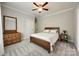 Well-lit bedroom features carpet floors, neutral walls, a wooden dresser, and a window for natural light at 364 Stone Cliff Ln, Clover, SC 29710
