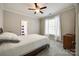 Inviting bedroom with plush carpeting, a bright window view, and a glimpse into the attached bathroom at 364 Stone Cliff Ln, Clover, SC 29710