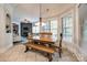 Bright dining area with a large wooden table, bench seating, and views into the cozy living space at 364 Stone Cliff Ln, Clover, SC 29710