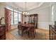 Elegant dining room with hardwood floors, a chandelier, and a large window with decorative curtains at 364 Stone Cliff Ln, Clover, SC 29710