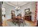 Dining room featuring hardwood floors, elegant wainscoting, and a decorative chandelier above the table at 364 Stone Cliff Ln, Clover, SC 29710