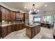 Gourmet kitchen features dark wood cabinets, granite countertops, stainless steel appliances, and an island at 364 Stone Cliff Ln, Clover, SC 29710