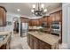 Spacious kitchen with stainless steel appliances, dark wood cabinetry, and a large center island at 364 Stone Cliff Ln, Clover, SC 29710