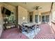Outdoor patio boasts a brick wall, television, ceiling fan, and a rustic dining set for entertaining at 364 Stone Cliff Ln, Clover, SC 29710