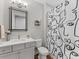 Stylish bathroom features a modern vanity, toilet, and shower-tub combo with a graphic shower curtain at 4012 Moxie Way, Charlotte, NC 28215
