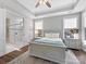 Bedroom boasts a trey ceiling, lots of natural light, and an ensuite bathroom with glass enclosed shower at 4012 Moxie Way, Charlotte, NC 28215