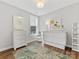 Well-lit bedroom with white furniture, including dressers, Murphy bed and a neutral rug over hardwood floors at 4012 Moxie Way, Charlotte, NC 28215