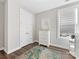 Neutral bedroom with white trim and doors, hardwood flooring and a decorative rug at 4012 Moxie Way, Charlotte, NC 28215