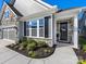 Inviting entrance with a stylish black front door, stone accents, and lush landscaping at 4012 Moxie Way, Charlotte, NC 28215