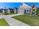 Charming home exterior with stone accents, well-manicured lawn, and a spacious driveway in a lovely neighborhood at 4012 Moxie Way, Charlotte, NC 28215