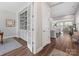 Elegant hallway featuring hardwood floors, a built-in bookcase, and an open view to the living spaces at 4012 Moxie Way, Charlotte, NC 28215