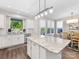 Bright kitchen features white cabinetry, stainless steel appliances, granite countertops, and a central island at 4012 Moxie Way, Charlotte, NC 28215