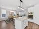 Bright kitchen features white cabinetry, stainless steel appliances, granite countertops, and a central island at 4012 Moxie Way, Charlotte, NC 28215