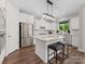 Bright kitchen features white cabinetry, stainless steel appliances, granite countertops, and a central island with barstool seating at 4012 Moxie Way, Charlotte, NC 28215