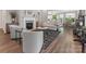 Open-concept living room with fireplace, hardwood floors, and view into the dining area at 4012 Moxie Way, Charlotte, NC 28215