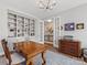 Inviting office space with built-in shelving, hardwood floors, and an open doorway at 4012 Moxie Way, Charlotte, NC 28215