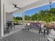 Inviting outdoor patio featuring a black and white patterned rug, stylish furniture, and scenic backyard view at 4012 Moxie Way, Charlotte, NC 28215