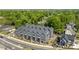 Aerial perspective of a townhouse complex with a modern design surrounded by green trees in a neighborhood at 4019 Plaza Row Ct, Charlotte, NC 28205