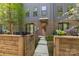Charming townhouse exterior featuring a walkway leading to the front door and a small patio area at 4019 Plaza Row Ct, Charlotte, NC 28205