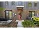 Inviting townhouse entrance featuring a charming pink door with a wreath and a cozy welcome mat at 4019 Plaza Row Ct, Charlotte, NC 28205
