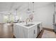 Bright kitchen with a large island and open view to the dining and living areas at 4019 Plaza Row Ct, Charlotte, NC 28205