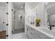 Modern bathroom featuring double sinks, a glass-enclosed shower, and elegant finishes for a luxurious experience at 4019 Plaza Row Ct, Charlotte, NC 28205
