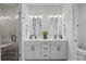 Elegant bathroom with dual vanities, modern fixtures, and a glass-enclosed shower for a spa-like experience at 4019 Plaza Row Ct, Charlotte, NC 28205