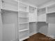 Spacious walk-in closet featuring ample shelving, hanging rods, and custom storage solutions for organized living at 4019 Plaza Row Ct, Charlotte, NC 28205