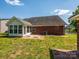 The home's backyard with brick patio, sunroom, and well-maintained grass and landscaping at 4203 Ethel Sustar Dr, Monroe, NC 28110