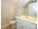 Bright bathroom featuring a toilet, sink with white vanity, and a large mirror at 4203 Ethel Sustar Dr, Monroe, NC 28110