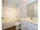 Bright and clean bathroom with shower-tub combo, vanity with white cabinets, and hard surface floors at 4203 Ethel Sustar Dr, Monroe, NC 28110