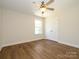 Bright bedroom with ceiling fan, and closet doors with hard surface flooring at 4203 Ethel Sustar Dr, Monroe, NC 28110